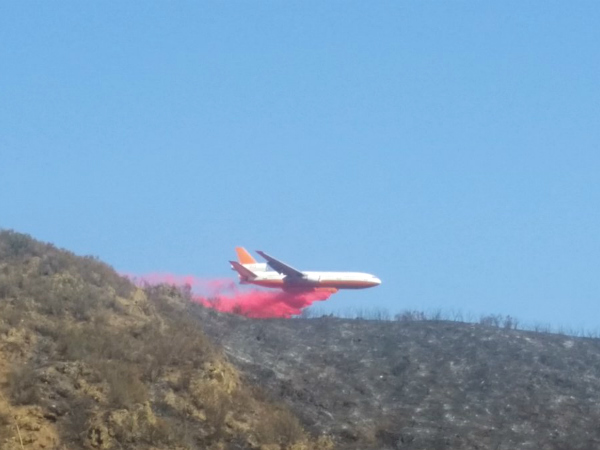 A plane drops fire retardant at the Mineral Fire in Fresno County.